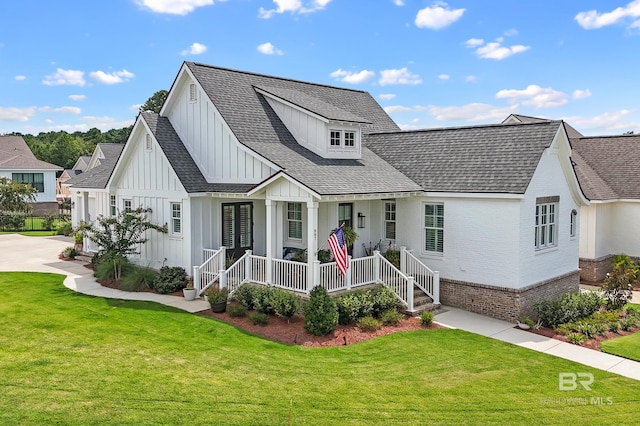 modern farmhouse style home featuring a porch and a front yard