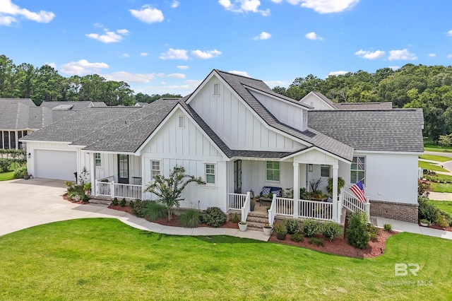 view of front facade featuring a garage, a porch, and a front lawn