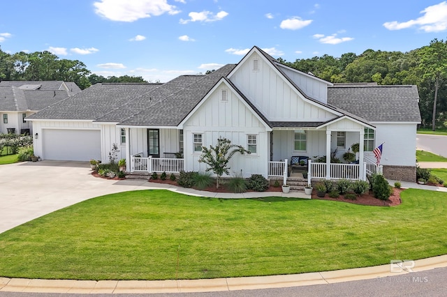 view of front facade with a garage, covered porch, and a front yard