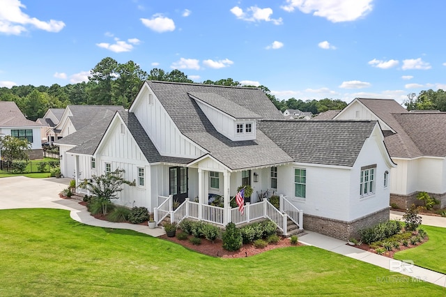 modern farmhouse with a garage, covered porch, and a front lawn