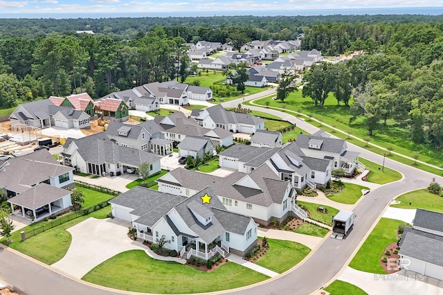 drone / aerial view with a forest view and a residential view