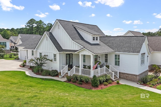 modern inspired farmhouse with brick siding, covered porch, a front lawn, concrete driveway, and board and batten siding