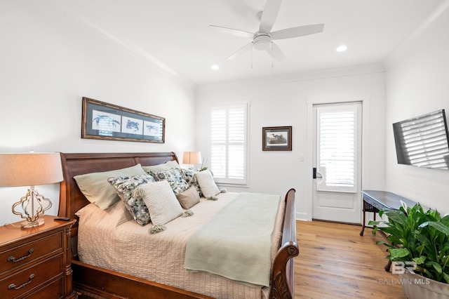 bedroom with multiple windows, ornamental molding, ceiling fan, and light hardwood / wood-style floors