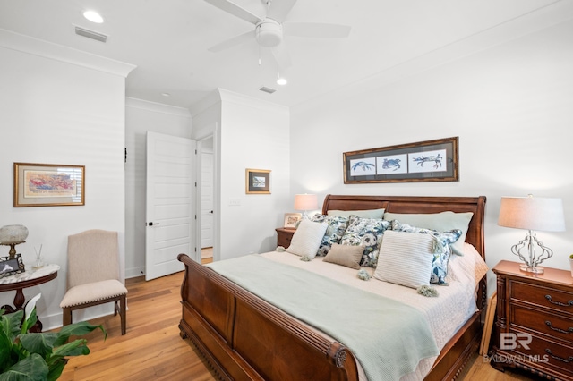 bedroom featuring ornamental molding, light wood-type flooring, and ceiling fan