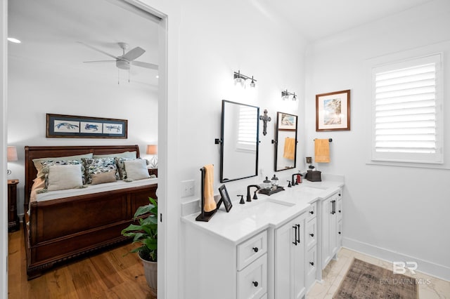 bathroom featuring ceiling fan, hardwood / wood-style floors, and double sink vanity