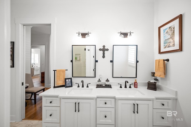 bathroom with tile patterned floors and dual bowl vanity