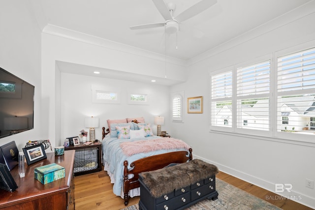 bedroom featuring crown molding, light hardwood / wood-style flooring, and ceiling fan