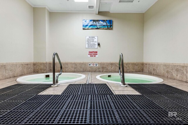 details featuring ornamental molding, a jacuzzi, and visible vents