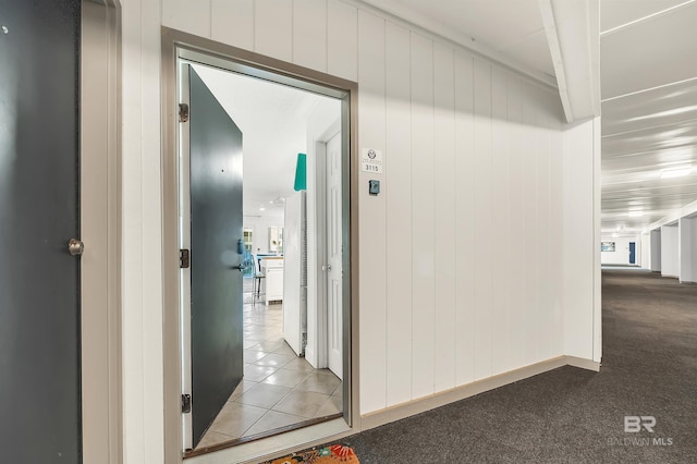 hallway with tile patterned flooring and carpet