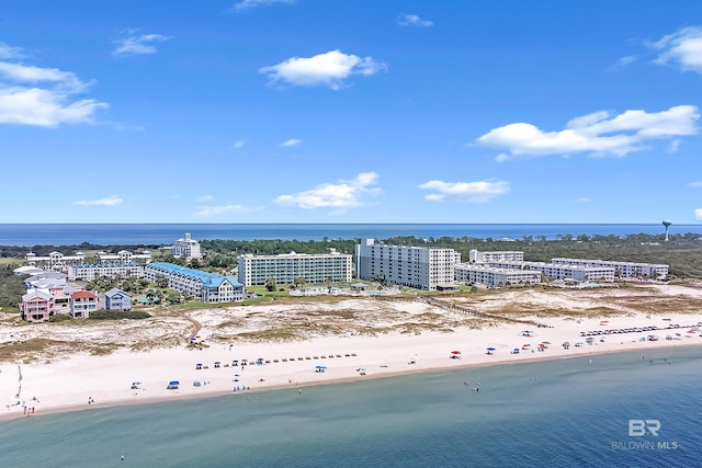 aerial view featuring a water view, a beach view, and a city view