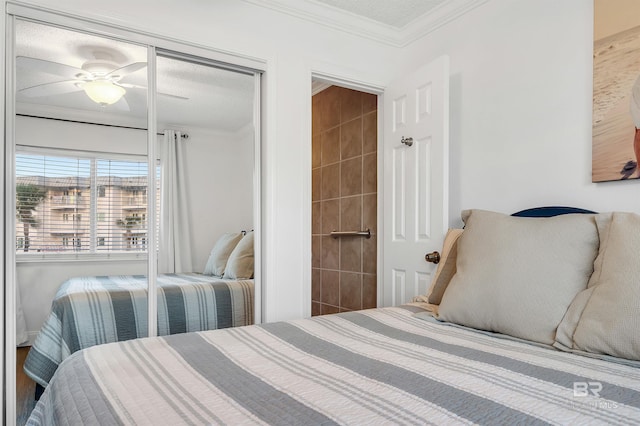 bedroom with a textured ceiling, ornamental molding, and ceiling fan