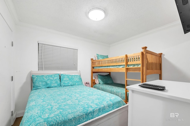 bedroom featuring ornamental molding and a textured ceiling