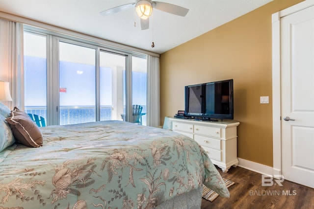 bedroom featuring a water view, dark wood-type flooring, and ceiling fan