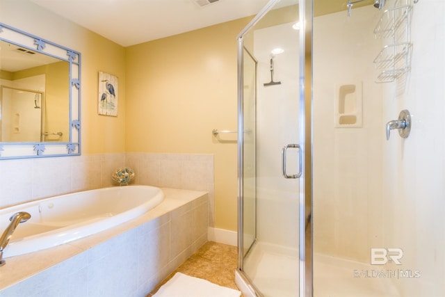 bathroom featuring tile patterned floors and separate shower and tub