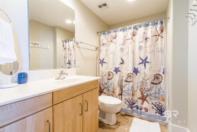 bathroom featuring vanity, tile patterned floors, and toilet