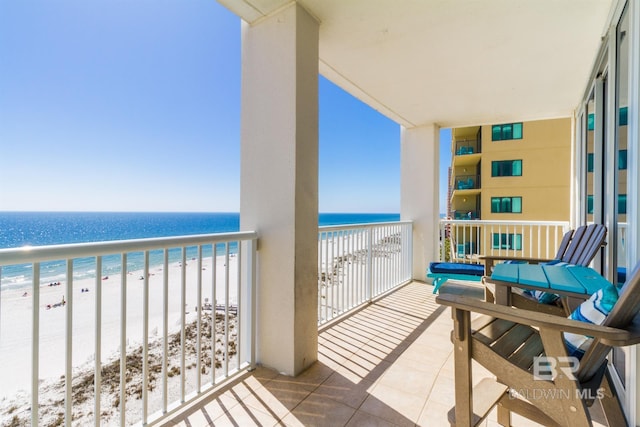 balcony with a water view and a beach view