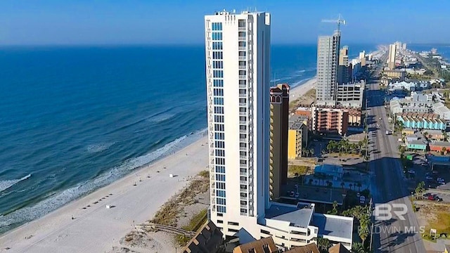 drone / aerial view featuring a water view and a view of the beach