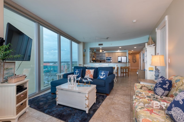 tiled living room with floor to ceiling windows