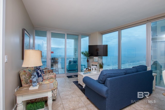 tiled living room with floor to ceiling windows and a healthy amount of sunlight