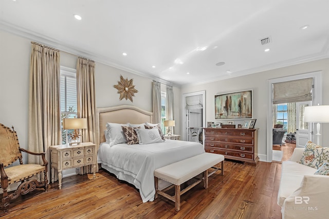 bedroom with ornamental molding, recessed lighting, visible vents, and hardwood / wood-style floors