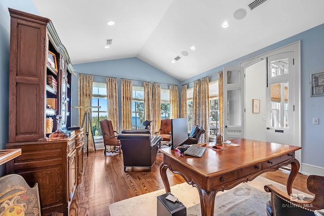 home office featuring recessed lighting, visible vents, vaulted ceiling, and wood finished floors