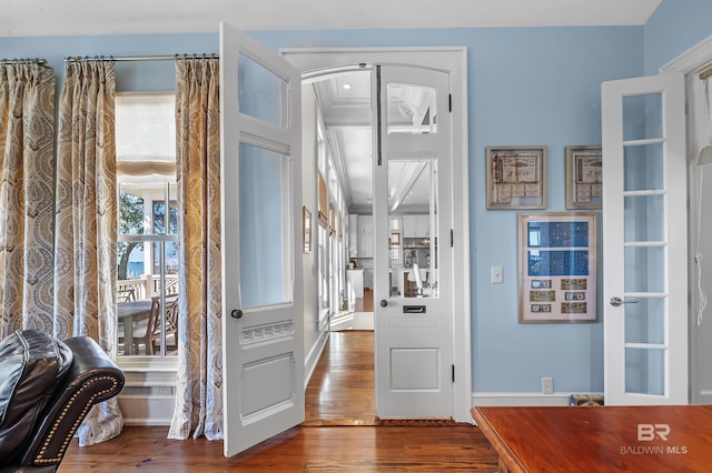 entrance foyer with baseboards and hardwood / wood-style floors