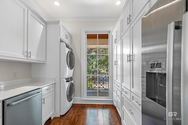 clothes washing area with laundry area, dark wood finished floors, stacked washer / dryer, crown molding, and recessed lighting