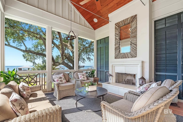 sunroom with a tile fireplace, wood ceiling, and vaulted ceiling