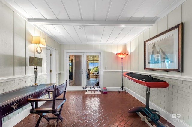 home office featuring brick floor and beam ceiling