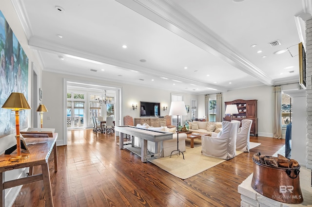 living area featuring dark wood-type flooring, a wealth of natural light, crown molding, and beamed ceiling