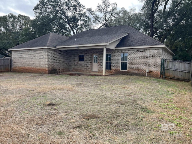 back of property featuring a lawn