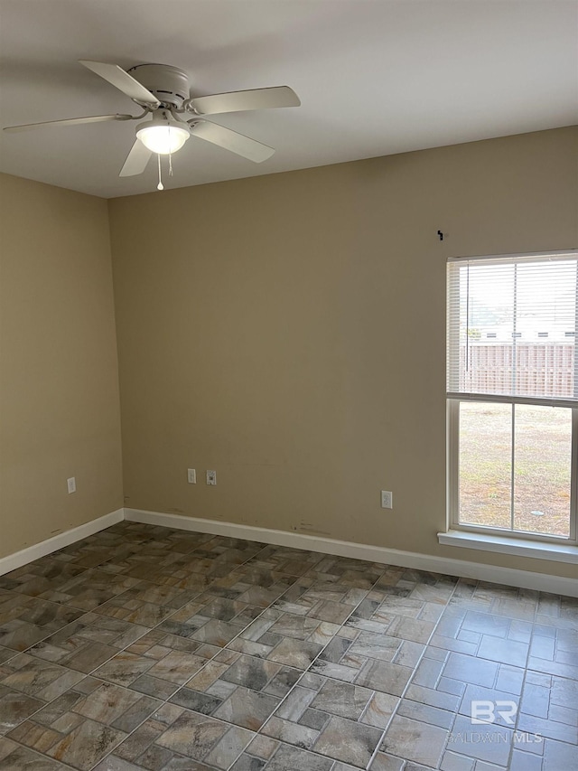 spare room with ceiling fan