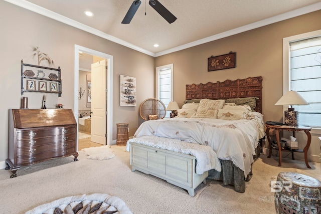 carpeted bedroom with recessed lighting, connected bathroom, ornamental molding, and ceiling fan