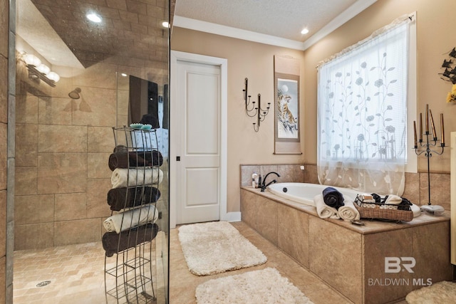 full bath with a textured ceiling, a garden tub, ornamental molding, and a tile shower