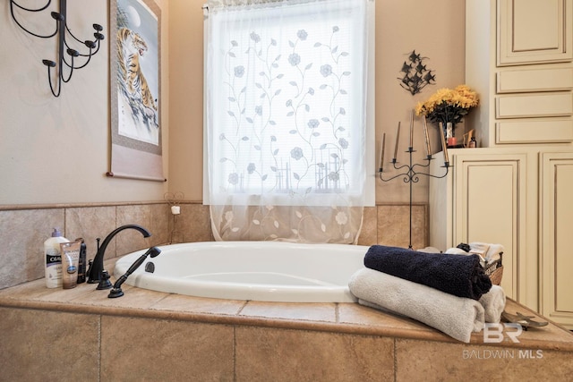 bathroom featuring a relaxing tiled tub