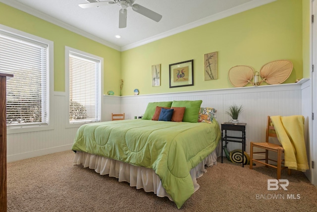 carpeted bedroom with crown molding and ceiling fan