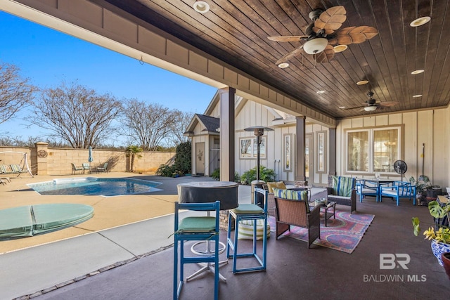 view of patio with a fenced in pool, outdoor lounge area, ceiling fan, and fence