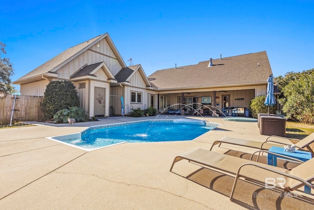 view of pool featuring pool water feature, ceiling fan, and a patio