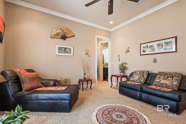 living room with ornamental molding, carpet floors, and ceiling fan