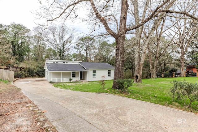 view of front of home featuring a porch, a front yard, and fence