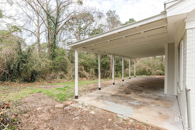 view of car parking featuring concrete driveway and an attached carport