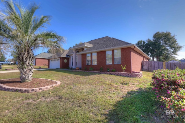 view of front of home with a front lawn and a garage