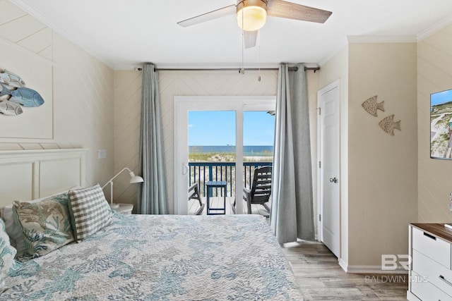 bedroom with a ceiling fan, wood finished floors, crown molding, baseboards, and access to exterior