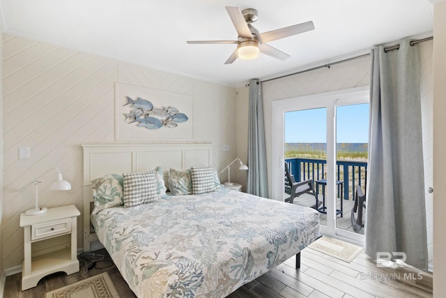 bedroom featuring wood finished floors, a ceiling fan, and access to outside