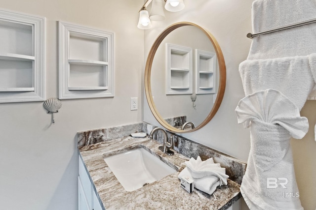 bathroom featuring built in features and vanity