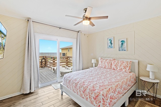 bedroom with wood finished floors, baseboards, ceiling fan, access to exterior, and crown molding