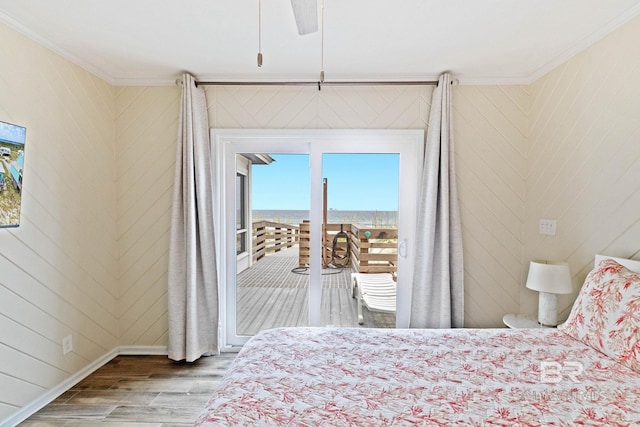 bedroom with access to exterior, crown molding, ceiling fan, and wood finished floors