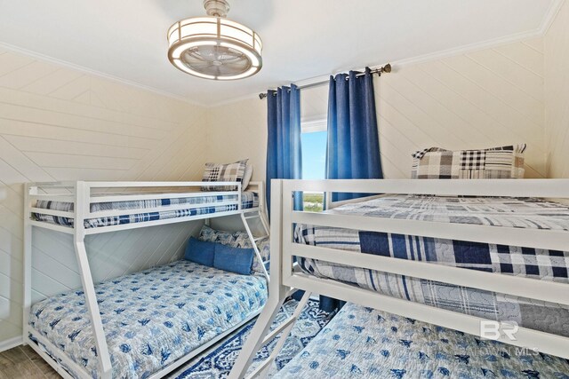 bedroom featuring wood finished floors and crown molding