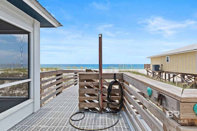 exterior space with a view of the beach, a water view, and central AC