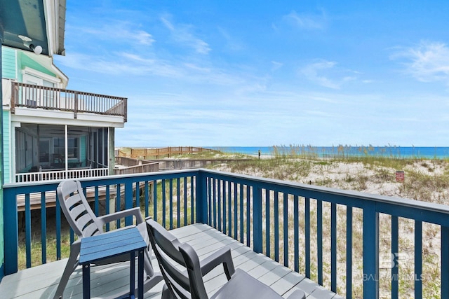 balcony with a beach view and a water view